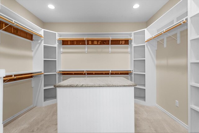 spacious closet featuring light carpet