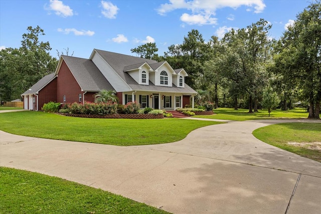 new england style home with covered porch and a front yard