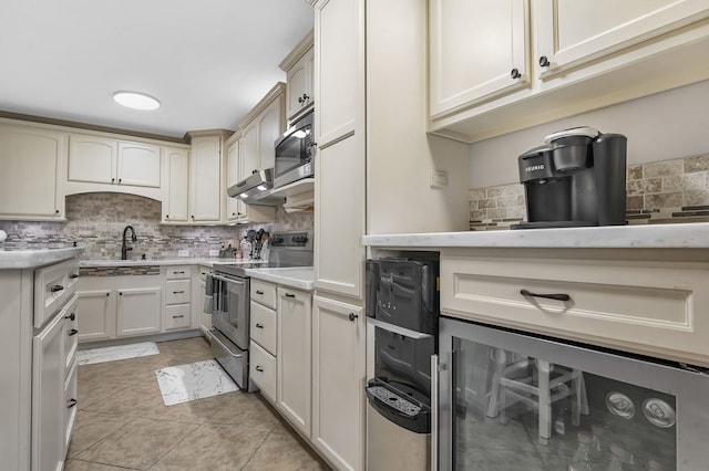 2528 Sam Rayburn Pkwy, Brookeland, TX 75931 - kitchen with electric range, decorative backsplash, beverage cooler, and light countertops
