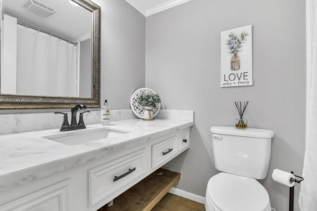 bathroom featuring crown molding, vanity, and toilet