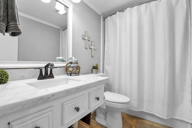 bathroom with vanity, toilet, and ornamental molding