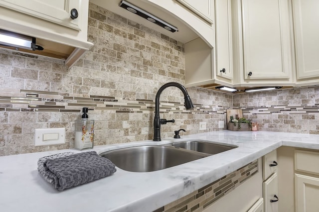 2528 Sam Rayburn Pkwy, Brookeland, TX 75931 - kitchen with a sink, backsplash, and light stone counters