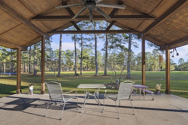 unfurnished sunroom featuring ceiling fan and lofted ceiling