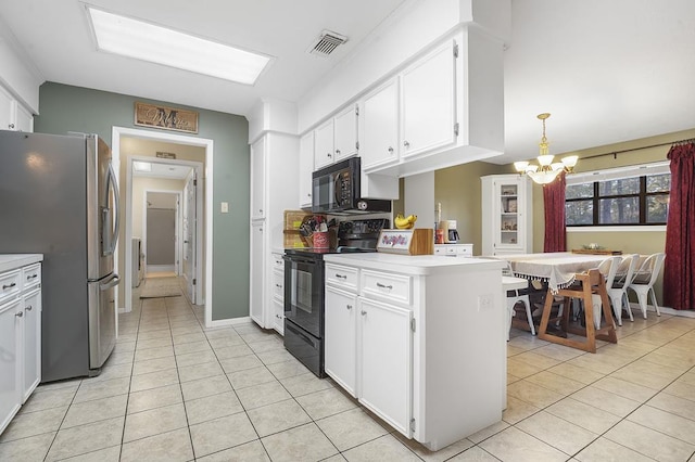 kitchen featuring black appliances, light tile patterned floors, decorative light fixtures, a chandelier, and white cabinetry