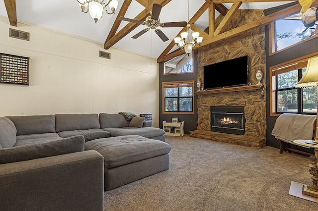 carpeted living room with beam ceiling, a stone fireplace, high vaulted ceiling, and ceiling fan with notable chandelier