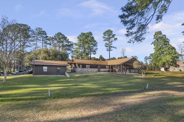 back of house with a lawn