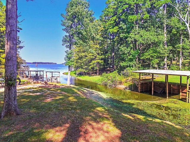 view of yard featuring a boat dock and a water view