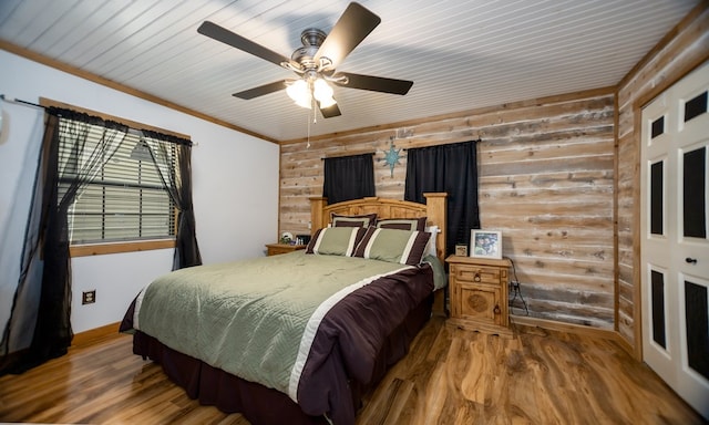 bedroom featuring hardwood / wood-style flooring, ceiling fan, ornamental molding, and wood ceiling