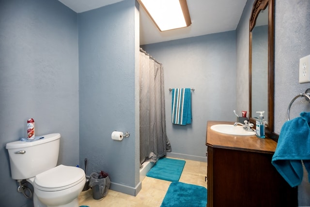 bathroom featuring tile patterned floors, vanity, toilet, and walk in shower