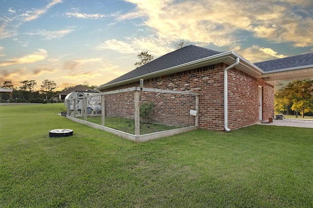 property exterior at dusk with a yard