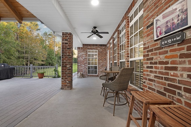 view of patio featuring area for grilling, ceiling fan, and a deck