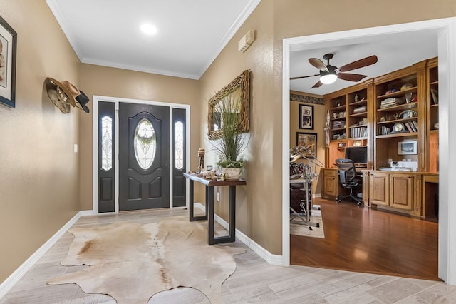 foyer with crown molding, light hardwood / wood-style flooring, and ceiling fan