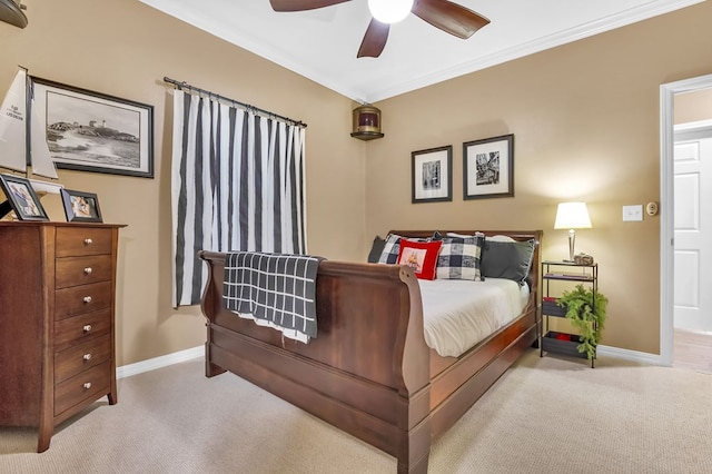 carpeted bedroom with ceiling fan and crown molding