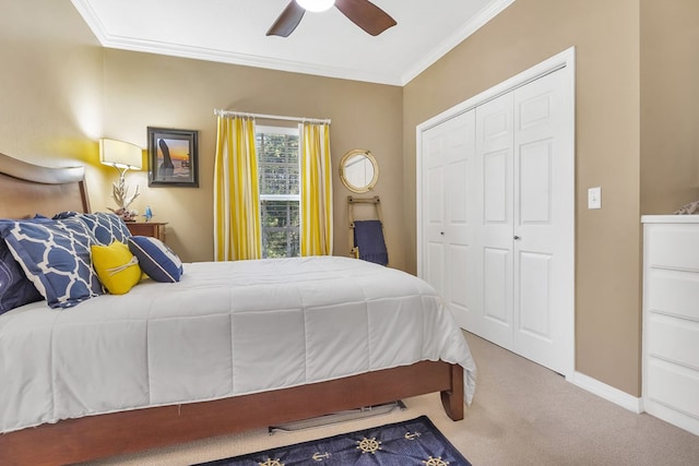 bedroom featuring a closet, ceiling fan, crown molding, and carpet floors