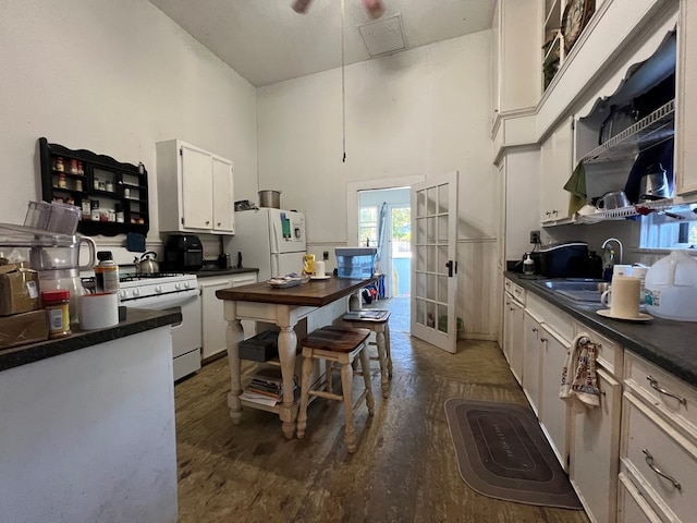 kitchen with french doors, sink, dark hardwood / wood-style floors, white appliances, and white cabinets