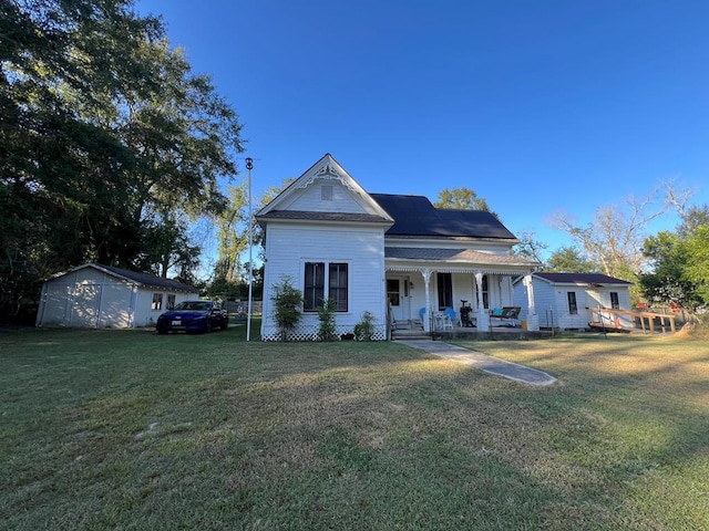 view of front of house featuring a storage unit, a porch, and a front yard