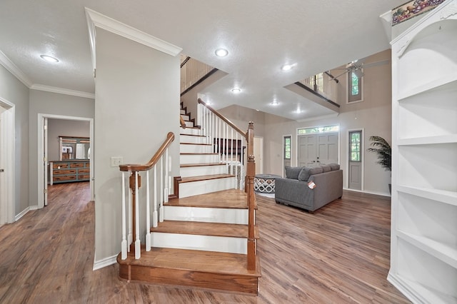 245 Shadow Dr, Hemphill, TX 75948 - staircase featuring crown molding, wood finished floors, baseboards, recessed lighting, and a textured ceiling