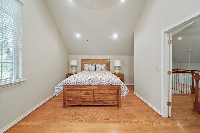 bedroom featuring light hardwood / wood-style flooring and vaulted ceiling