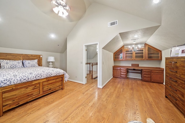 bedroom with ceiling fan, light hardwood / wood-style flooring, and lofted ceiling