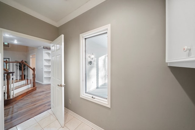 interior space featuring light hardwood / wood-style floors and ornamental molding