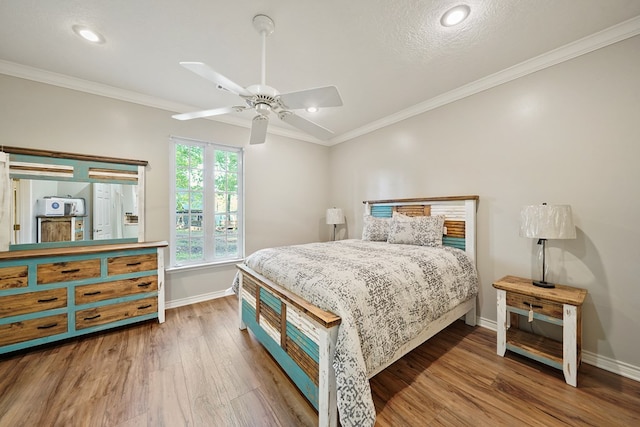 bedroom with hardwood / wood-style floors, ceiling fan, ornamental molding, and a textured ceiling