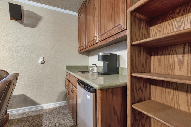 kitchen with stainless steel dishwasher, carpet floors, crown molding, and a textured ceiling