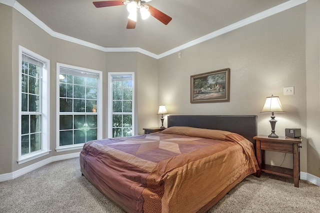 carpeted bedroom with ceiling fan and ornamental molding