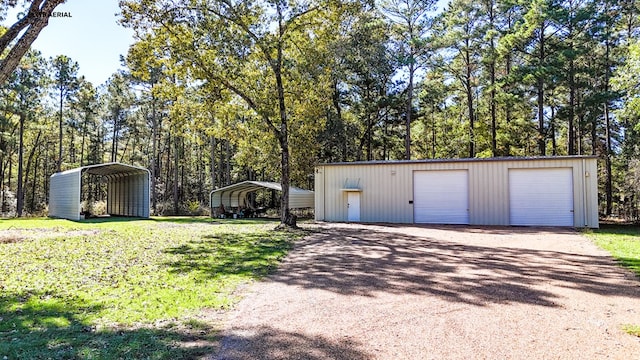 garage featuring a carport and a yard