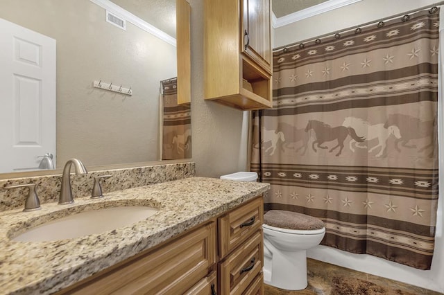 bathroom with crown molding, vanity, and toilet