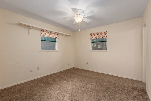 carpeted empty room featuring ceiling fan and a textured ceiling