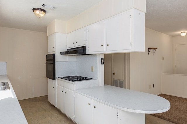 kitchen featuring white cabinetry, tasteful backsplash, black appliances, and kitchen peninsula