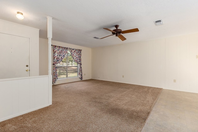 carpeted empty room featuring a textured ceiling and ceiling fan