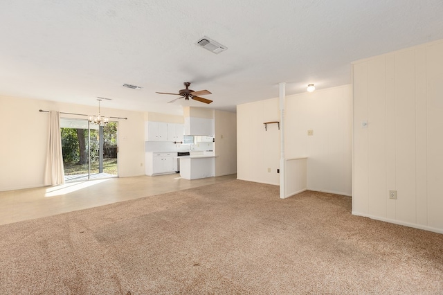 unfurnished living room with ceiling fan with notable chandelier, light carpet, and a textured ceiling