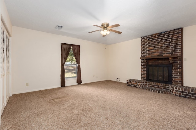 unfurnished living room with ceiling fan, carpet flooring, a textured ceiling, and a fireplace