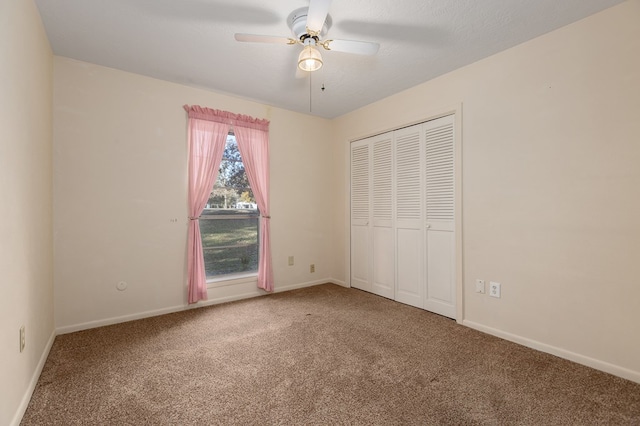 unfurnished bedroom with carpet flooring, a textured ceiling, ceiling fan, and a closet