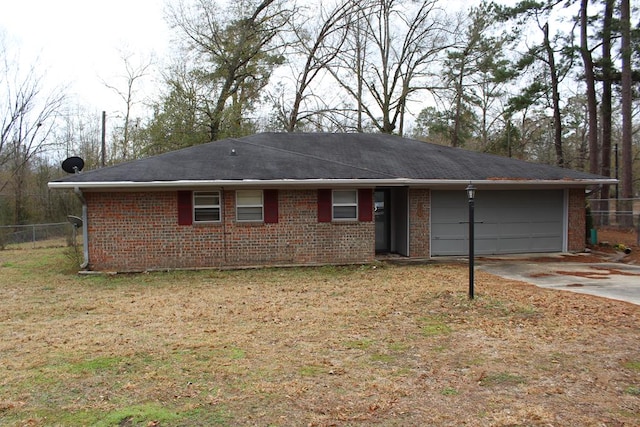 view of front facade featuring concrete driveway, an attached garage, fence, and brick siding