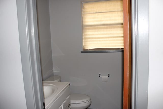 bathroom featuring toilet and vanity