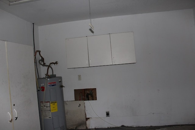 clothes washing area with laundry area, electric dryer hookup, electric water heater, and washer hookup