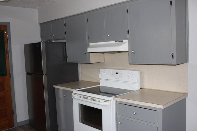 kitchen with electric range, under cabinet range hood, and gray cabinetry