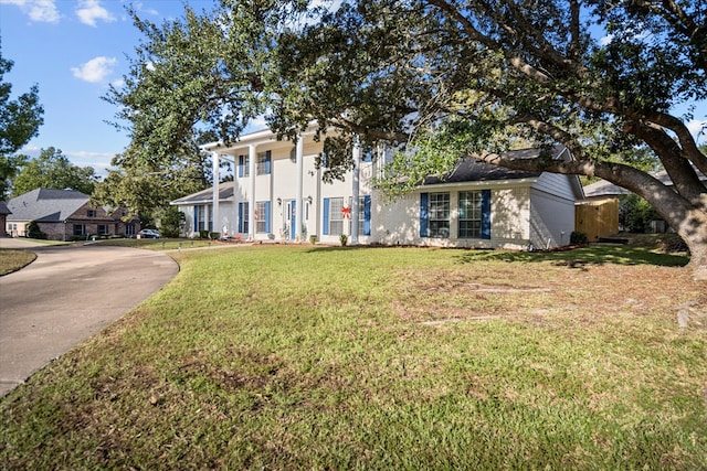 neoclassical home with a front lawn