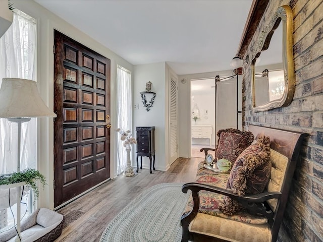 entrance foyer featuring a wealth of natural light, a barn door, and wood finished floors