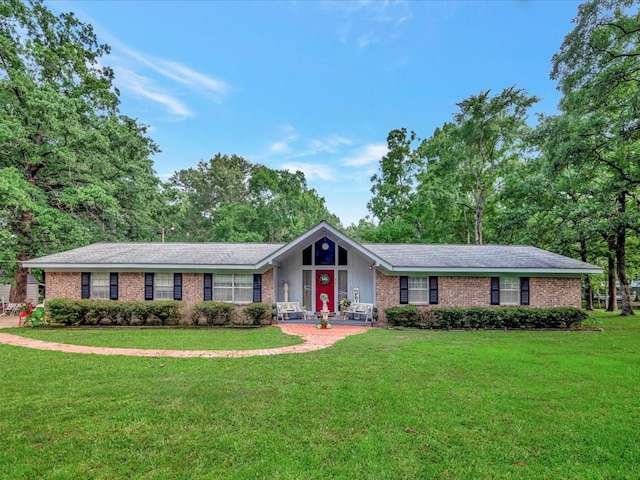 ranch-style house with a front yard and brick siding