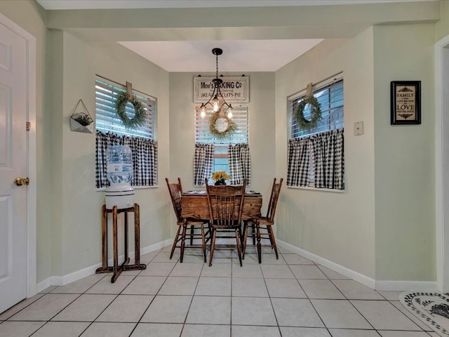 dining space with light tile patterned floors and baseboards