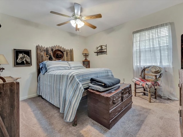 bedroom with baseboards, carpet floors, and ceiling fan