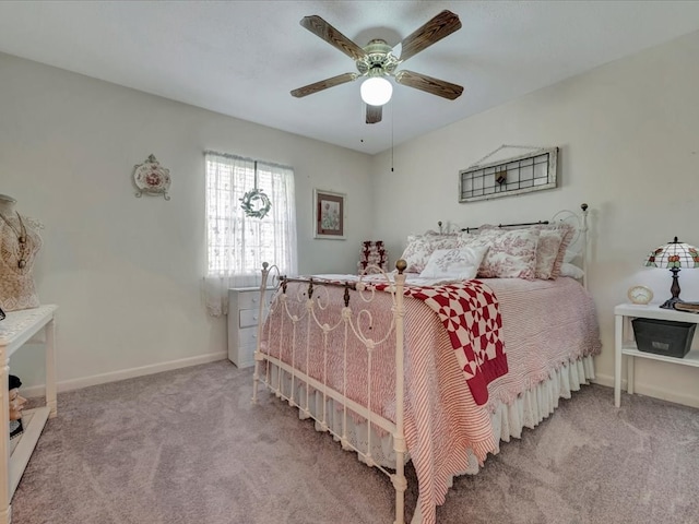 carpeted bedroom with baseboards and a ceiling fan