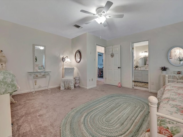 carpeted bedroom with visible vents, connected bathroom, a ceiling fan, and baseboards