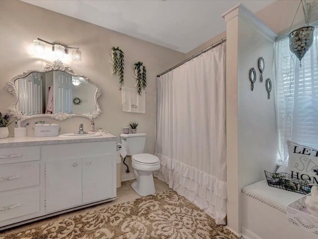 bathroom featuring tile patterned floors, toilet, vanity, and a shower with shower curtain