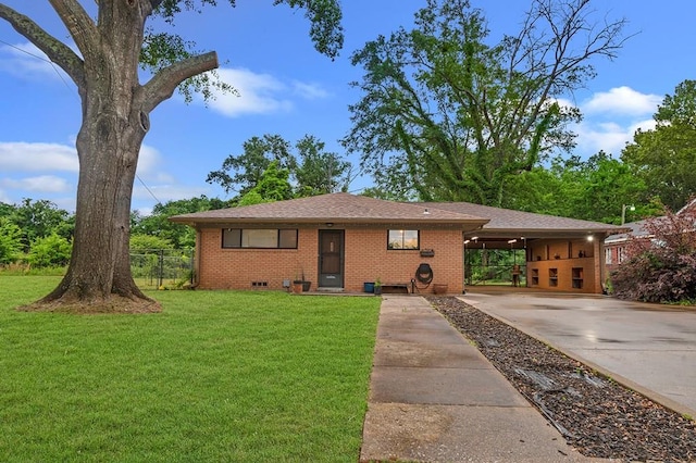 view of front facade with concrete driveway, brick siding, fence, and a front yard