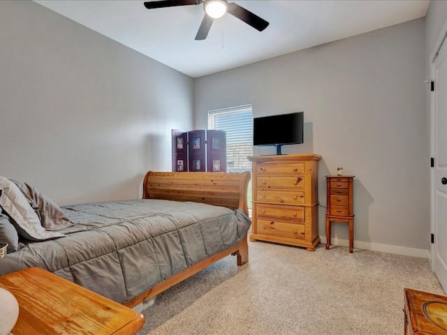 carpeted bedroom with a ceiling fan and baseboards