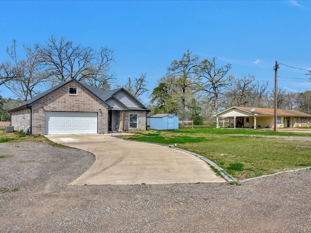 view of front of property with a storage shed, concrete driveway, an attached garage, a front yard, and brick siding